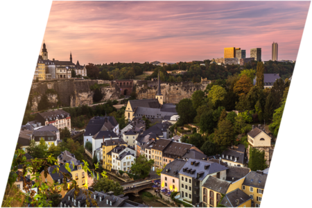 Overview of Luxembourg City, Grund and Kirchberg at sunset.